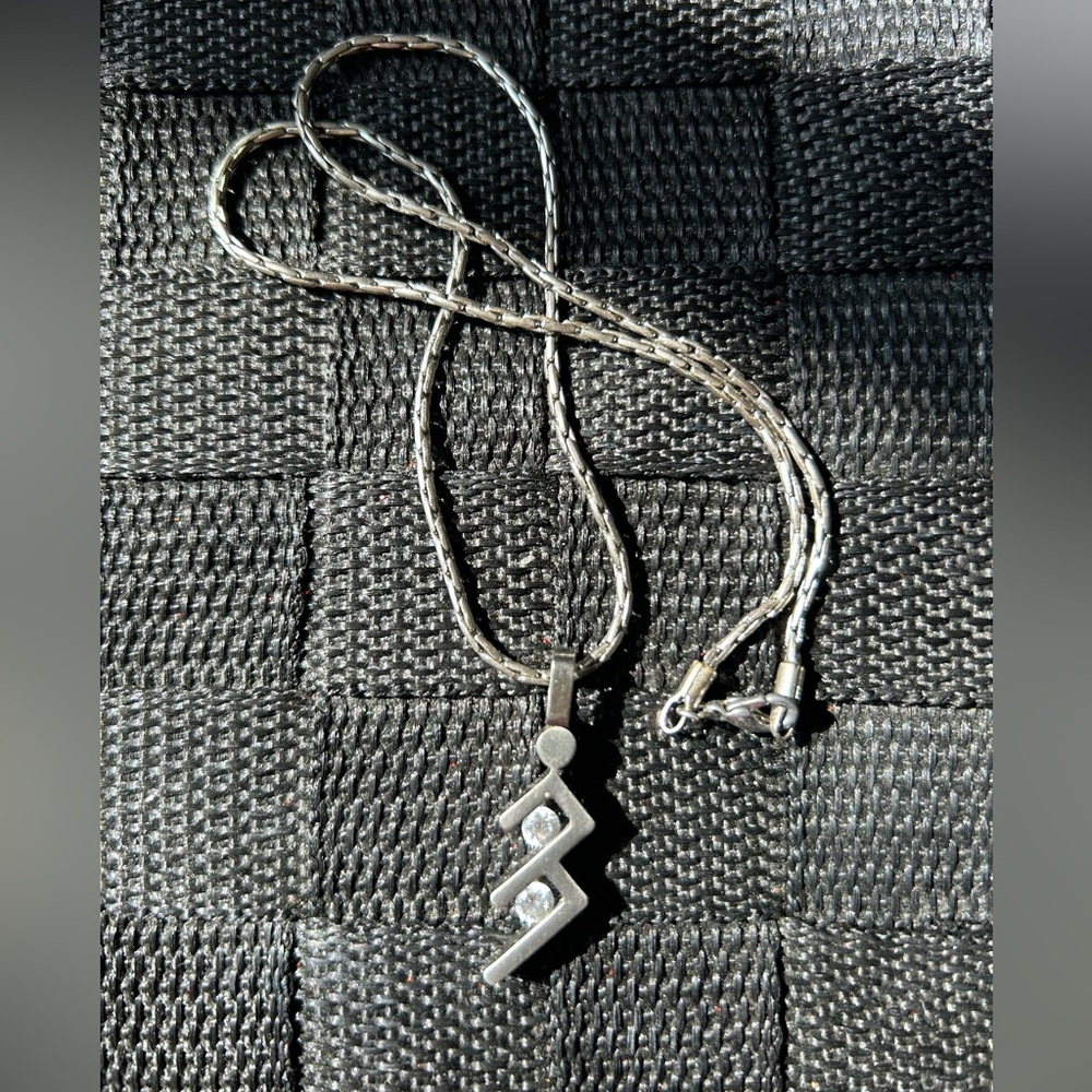 Silvery necklace comes with a chain